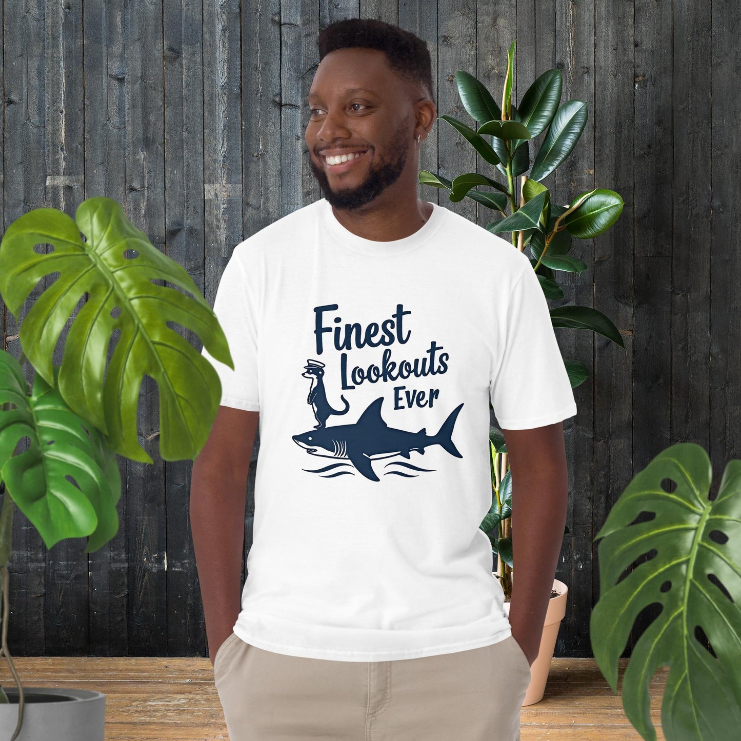 Man wearing white 100% ring-spun cotton tee with 'Finest Lookouts Ever' shark & otter graphic, funny animal duo design