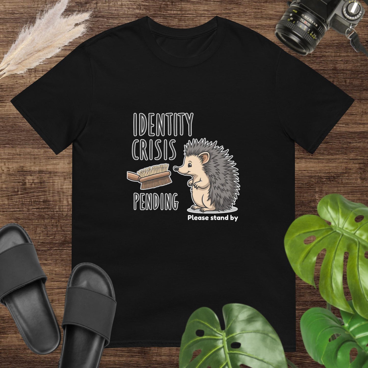 Unisex t-shirt. "Identity crisis" text featuring a hedgehog looking at a double sided brush