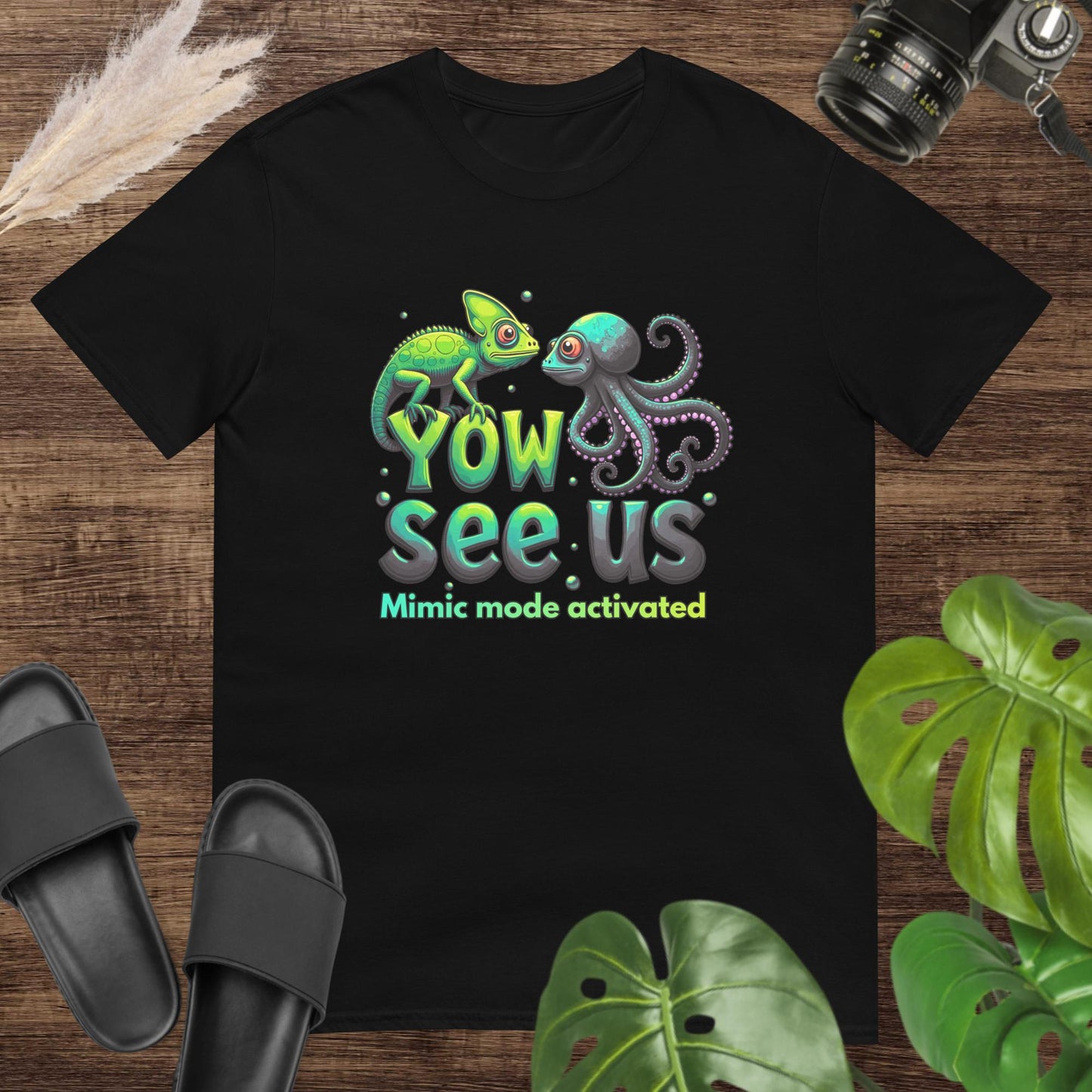 Black t-shirt featurung a chameleon and an octopus shirt with the text "Yow see us. Mimic mode activated"