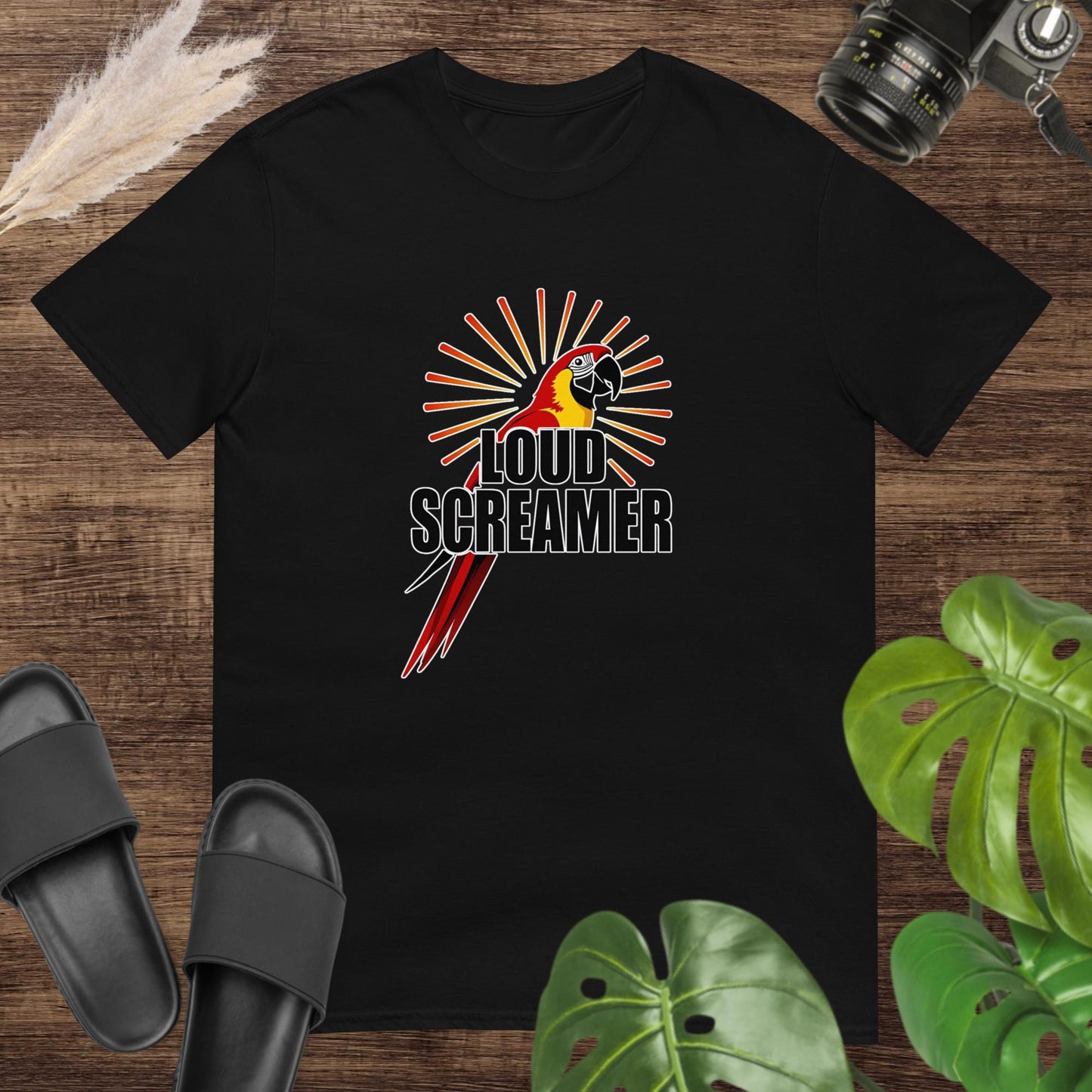 Black t-shirt featuring a colorful parrot with the words “LOUD SCREAMER” and sunburst lines.