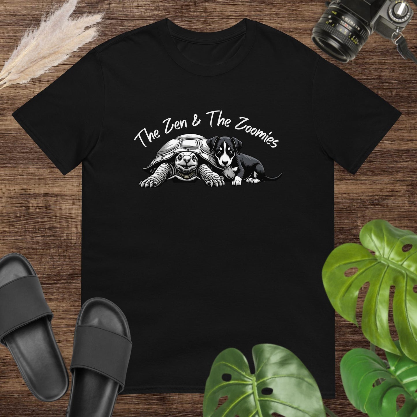 Black t-shirt featuring a cute black & white turtle and puppy with the text "The Zne & The Zoomies"