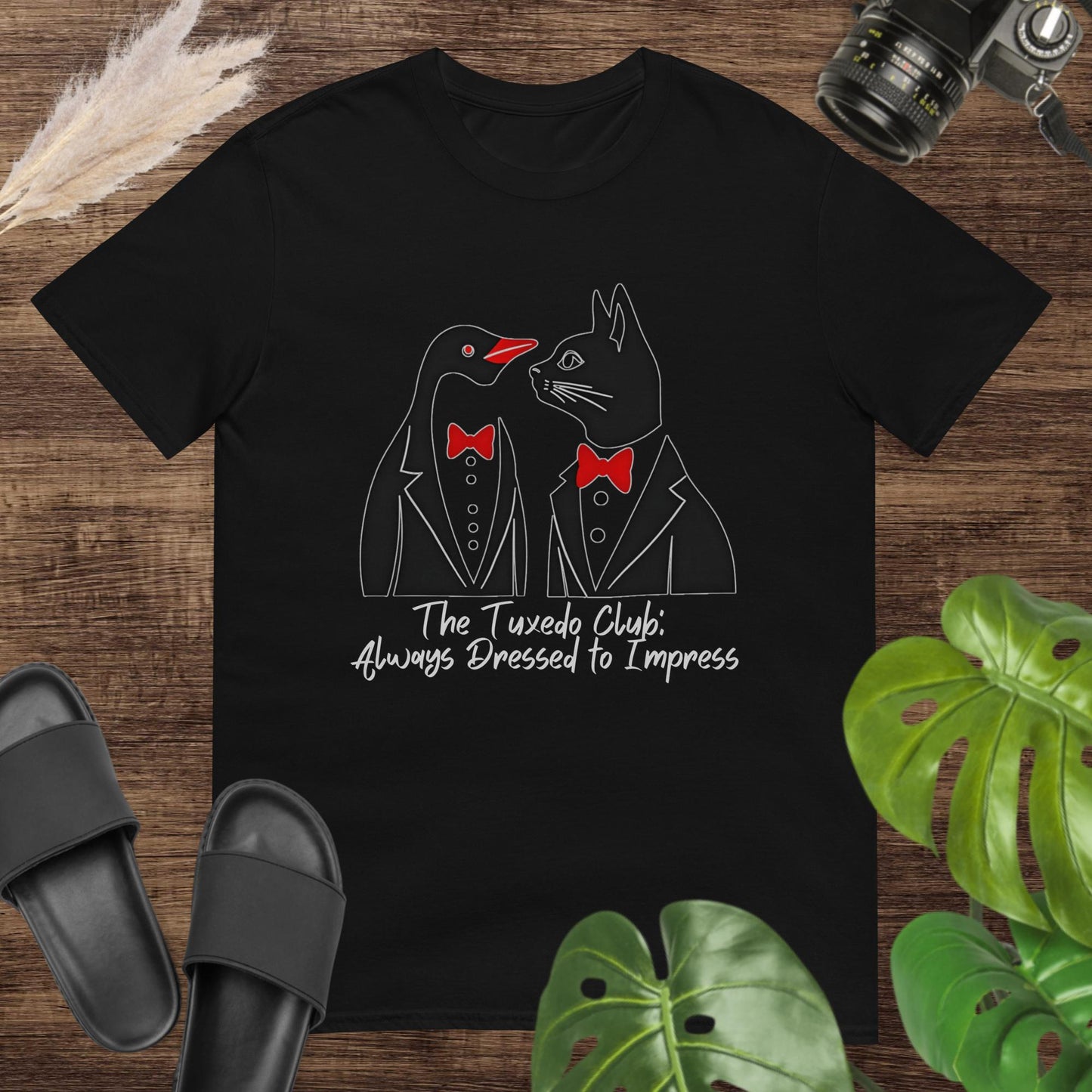 Funny black t-shirt featuring a penguin and a cat with tuxedo and text The tuxedo club