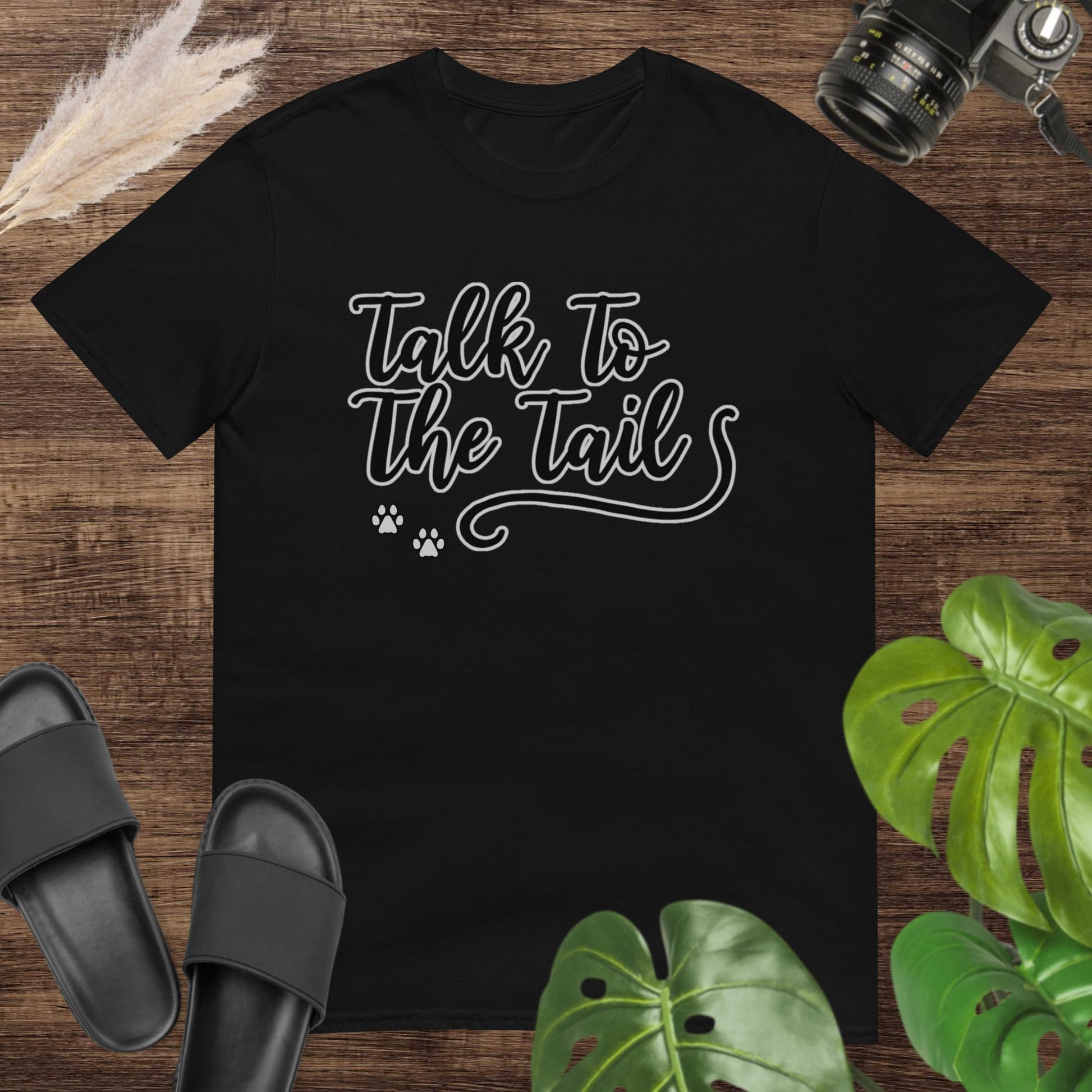 Funny black t-shirt featuring a tail and 2 little paws after the text Talk to the Tail