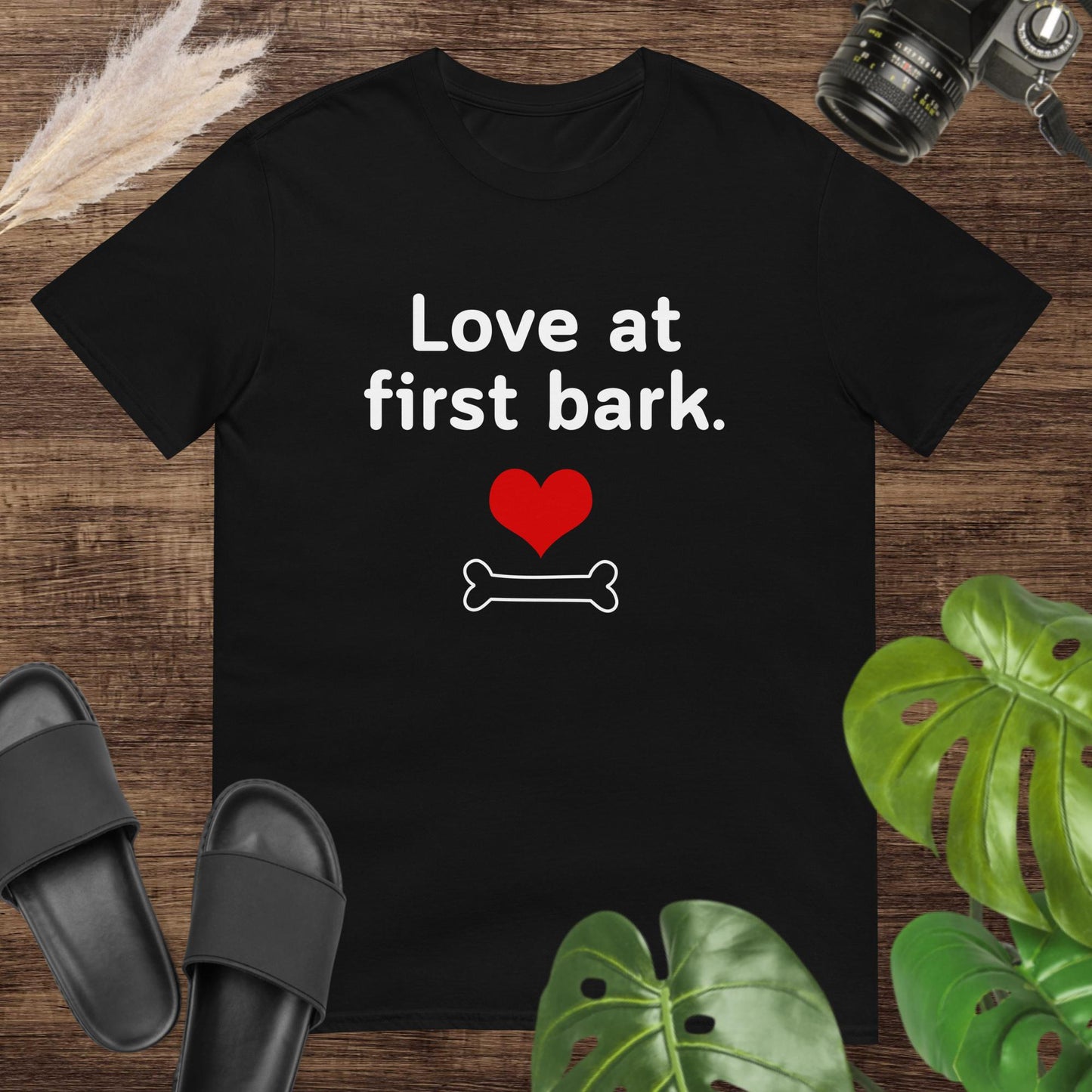 Cute black t-shirt featuring a heart and a bone with text Love at first bark
