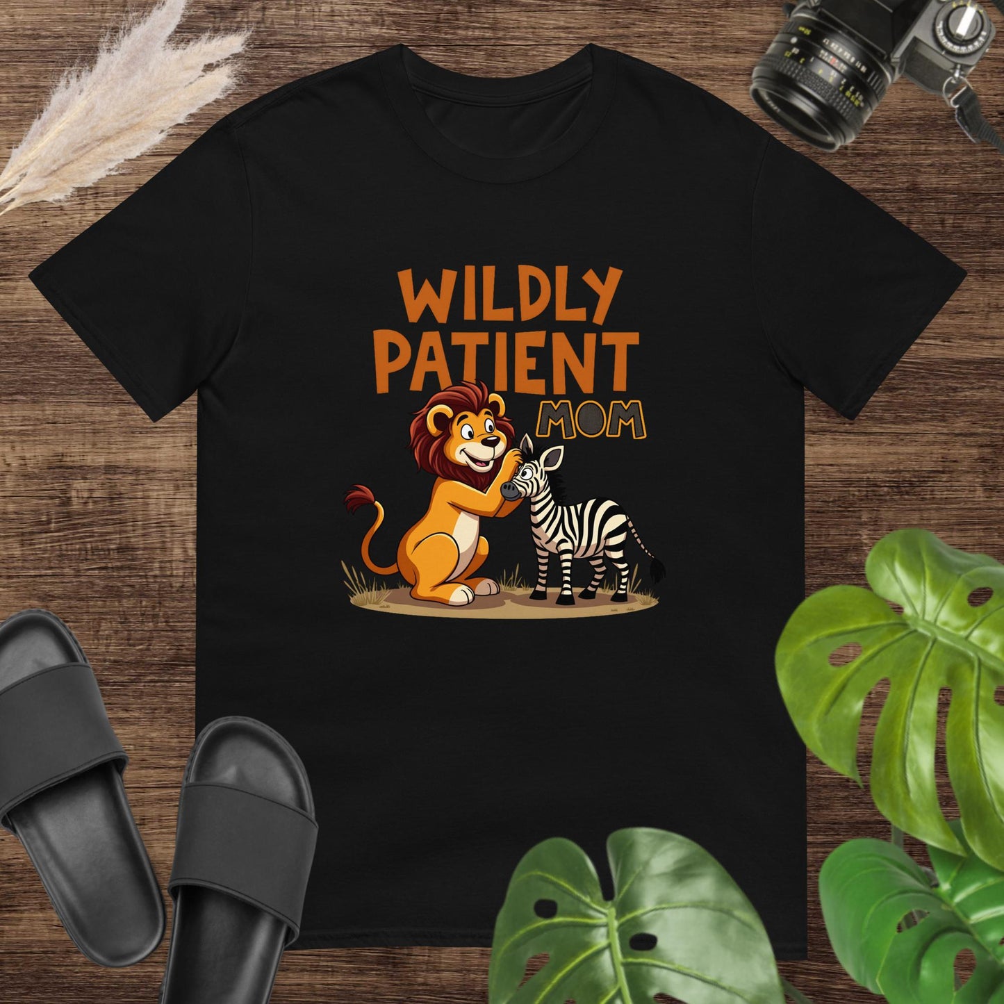 Cute unexpected duo "Wildly patient mom" black t-shirt design with a lion and a zebra