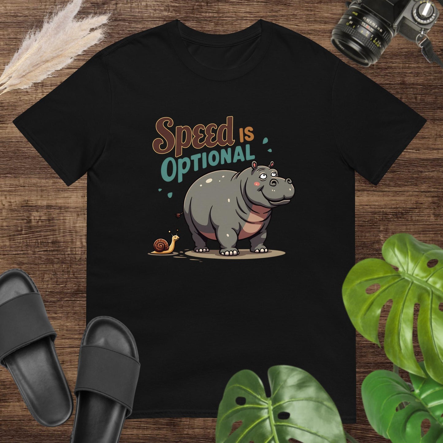 Unisex black t-shirt featuring a hippo and snail with the text Speed Is Optional.