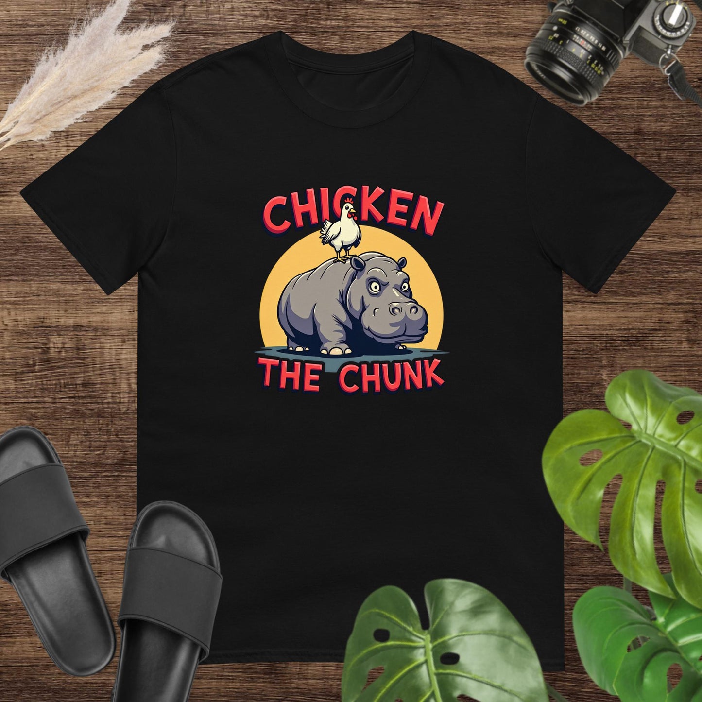 Unisex black t-shirt featuring a chicken standing on a hippo with the text Chicken the Chunk.