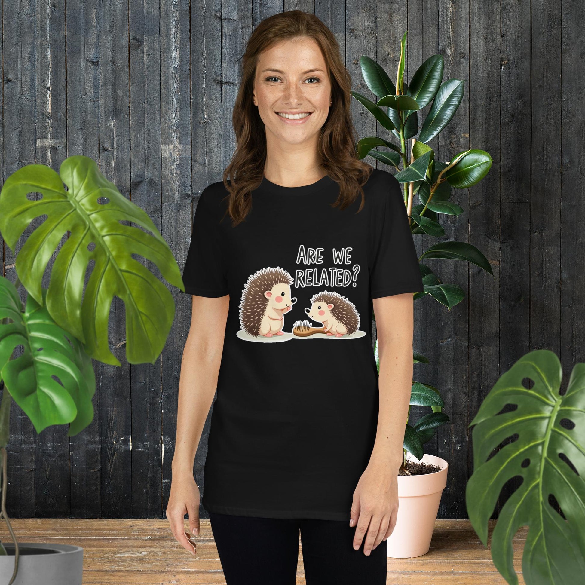 Woman wearing black unisex tee with cute hedgehog graphic asking 'Are We Related?' perfect gift for pet lovers