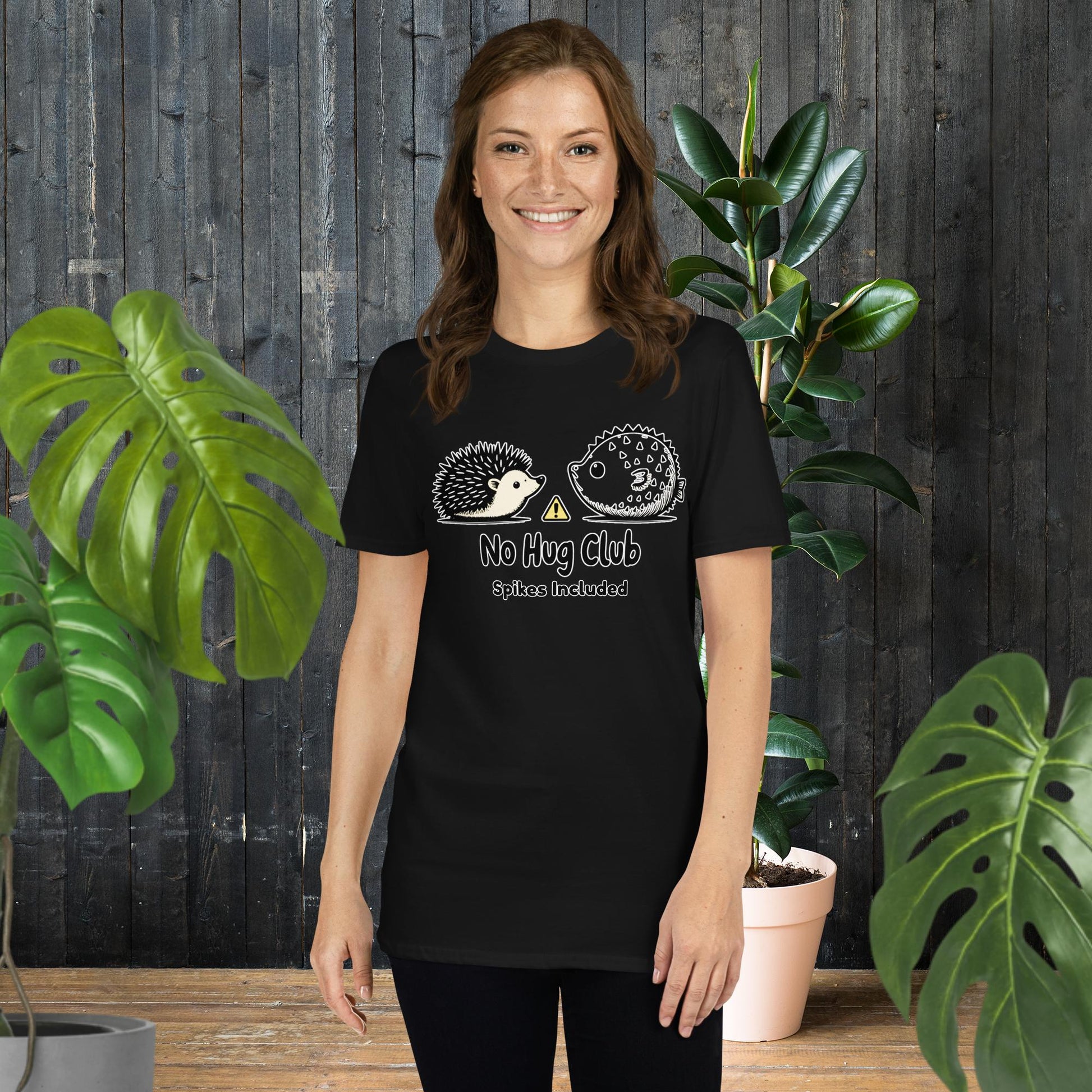 Woman wearing black funny animal graphic tee with hedgehog and pufferfish, 'No Hug Club' text, unisex soft cotton shirt
