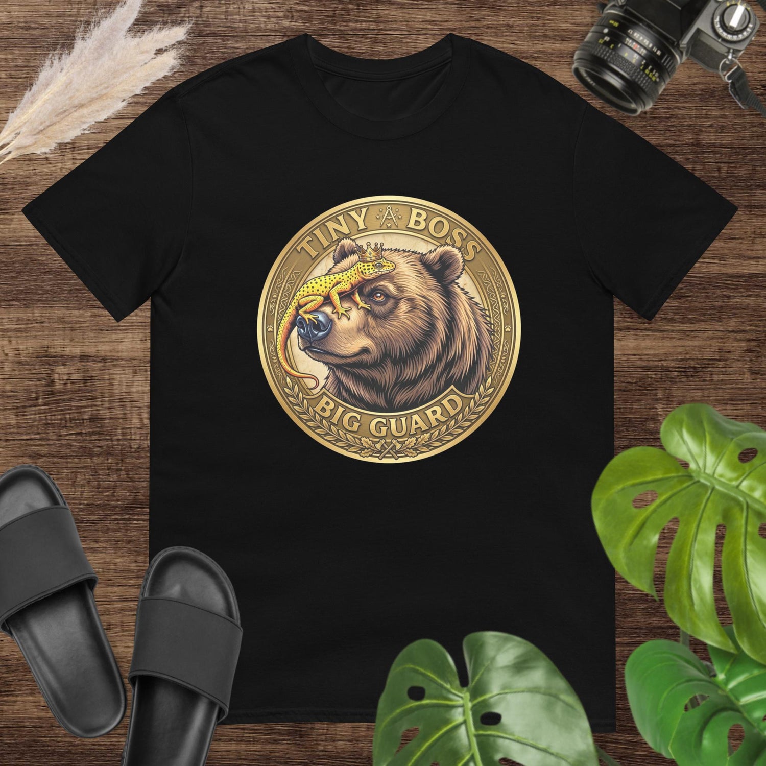 Black unisex tee with 'Tiny Boss Big Guard' bear and gecko graphic, 100% ring-spun cotton