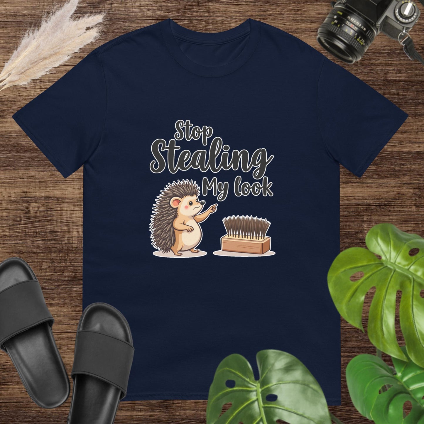 Navy t-shirt featuring a hedgehog pointing at a hairbrush with the text "Stop stealing my look"