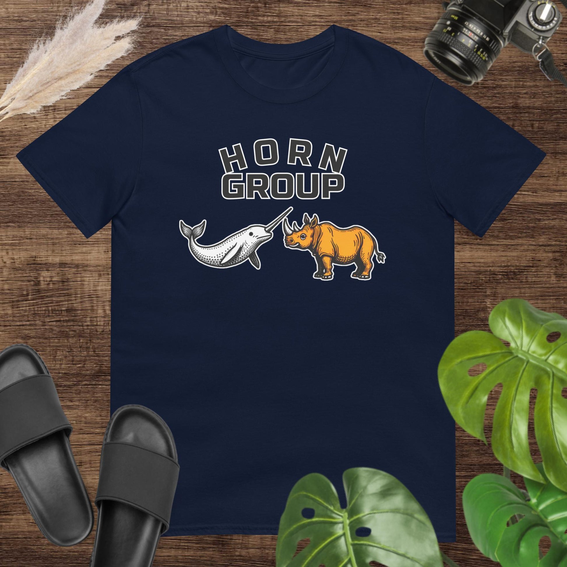 Unisex navy t-shirt featuring a narwhal and a rhinoceros with the words “HORN Group.”