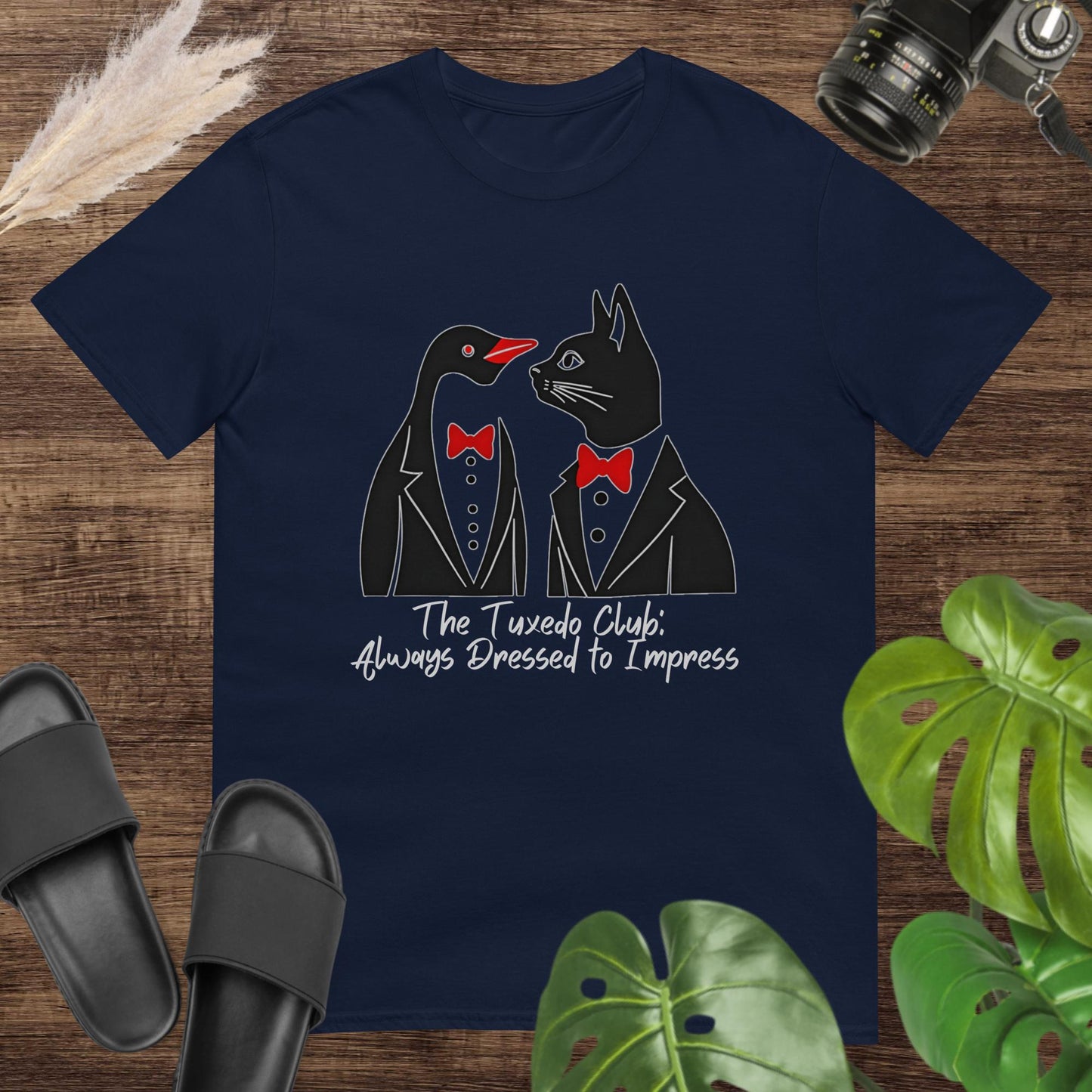 Funny navy t-shirt featuring a penguin and a cat with tuxedo and text The tuxedo club