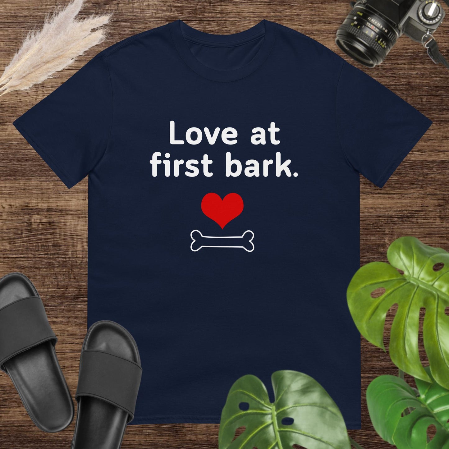 Cute navy t-shirt featuring a heart and a bone with text Love at first bark