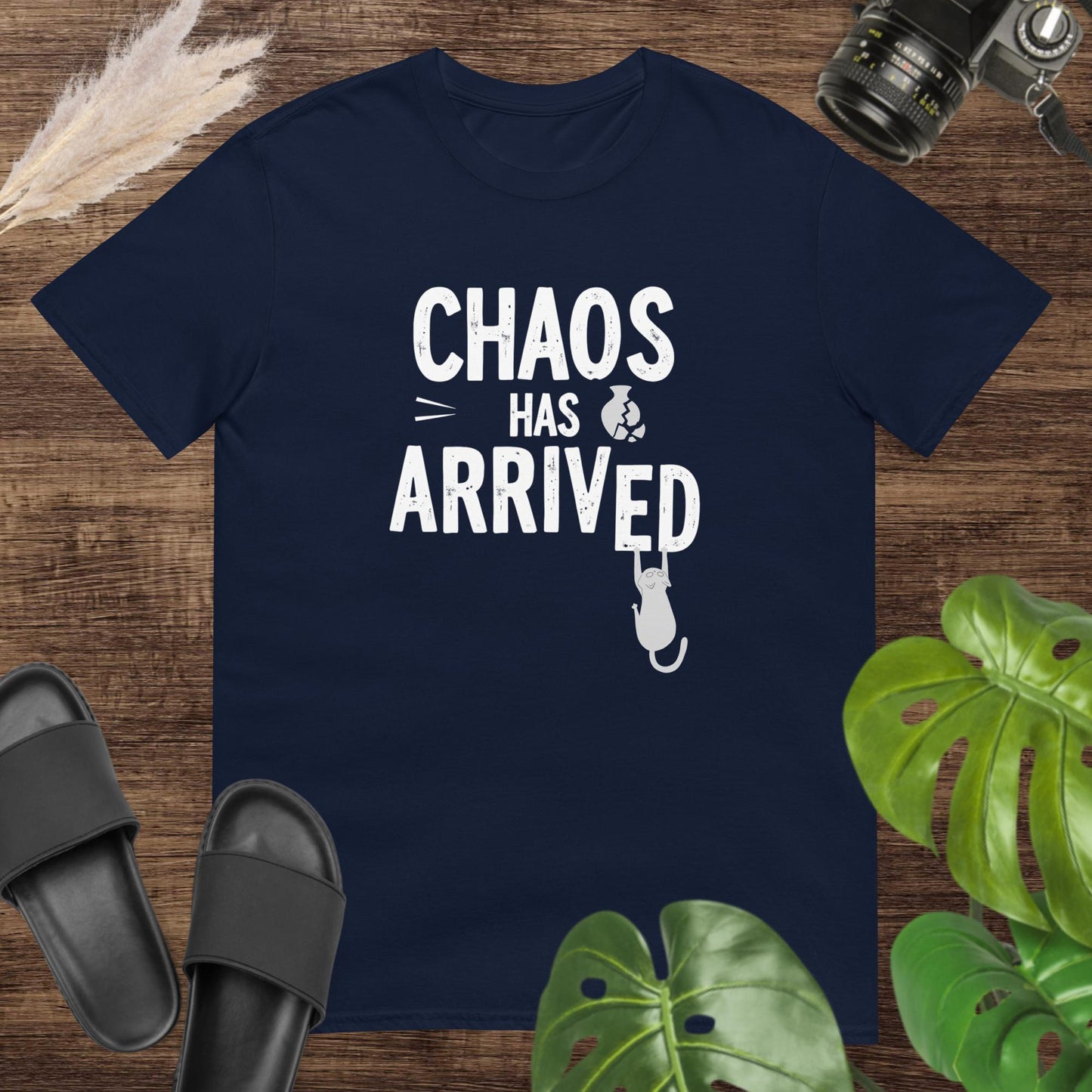 Funny navy t-shirt featuring a cat breaking the word arrived in the text chaos has arrived