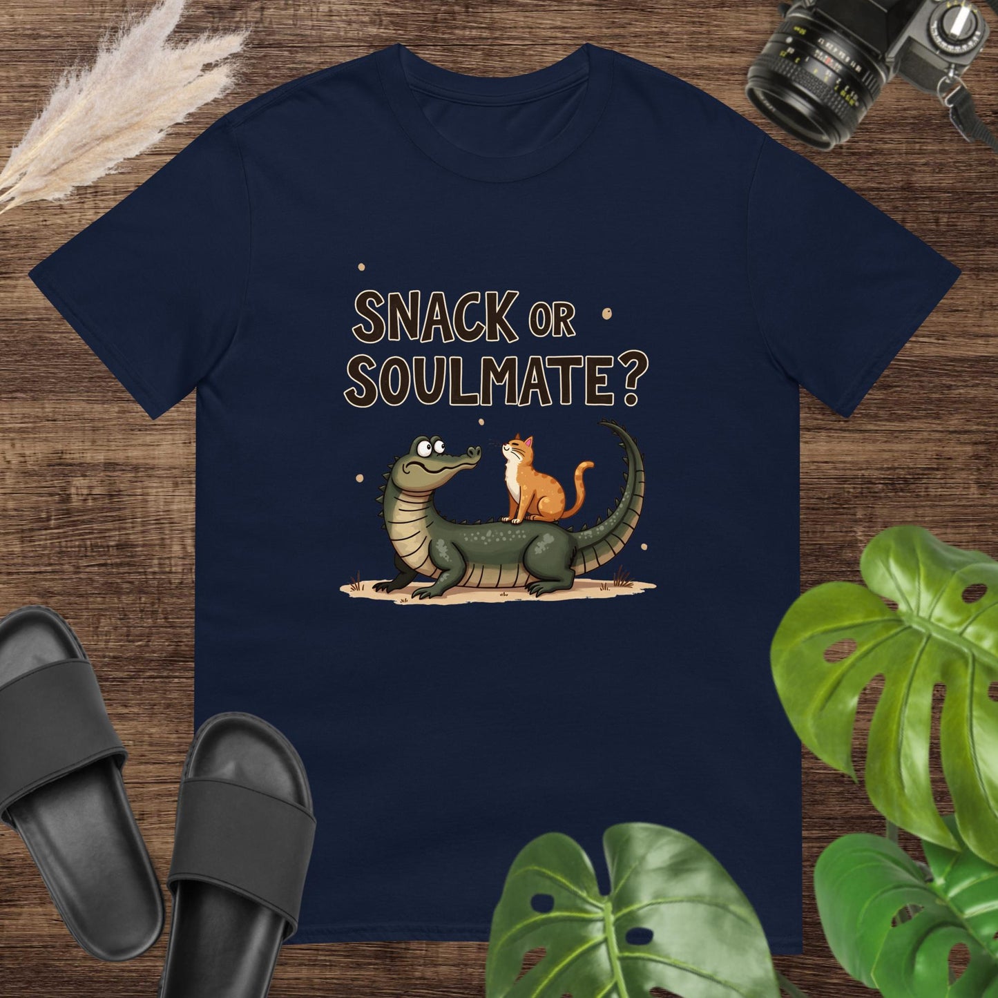 Unisex navy t-shirt featuring a crocodile and cat with the text Snack or Soulmate?