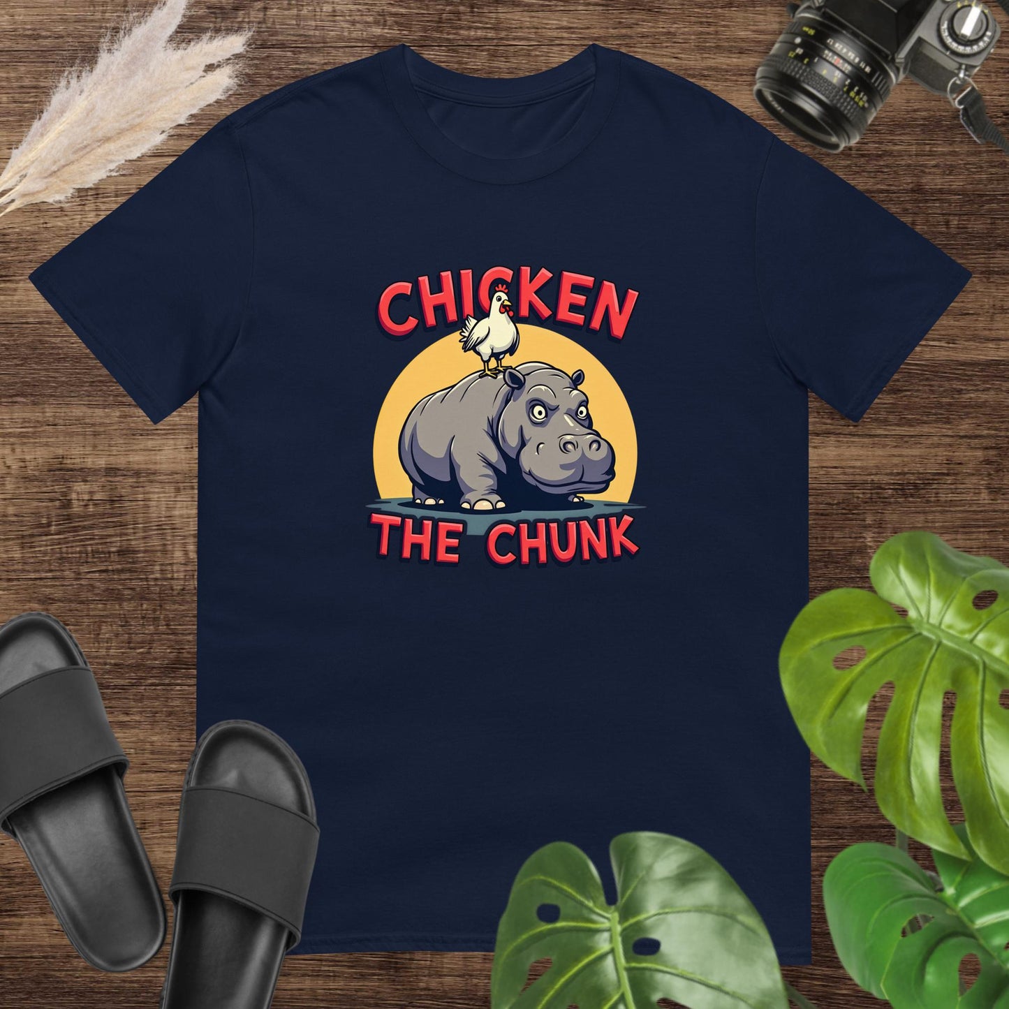 Unisex navy t-shirt featuring a chicken standing on a hippo with the text Chicken the Chunk.