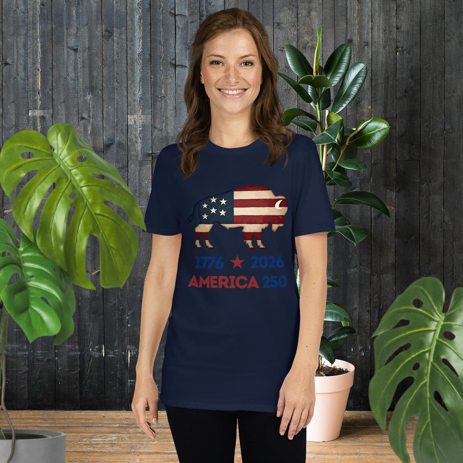 Woman wearing navy t-shirt with American flag bison graphic, '1776 2026 America 250' text, unisex fit