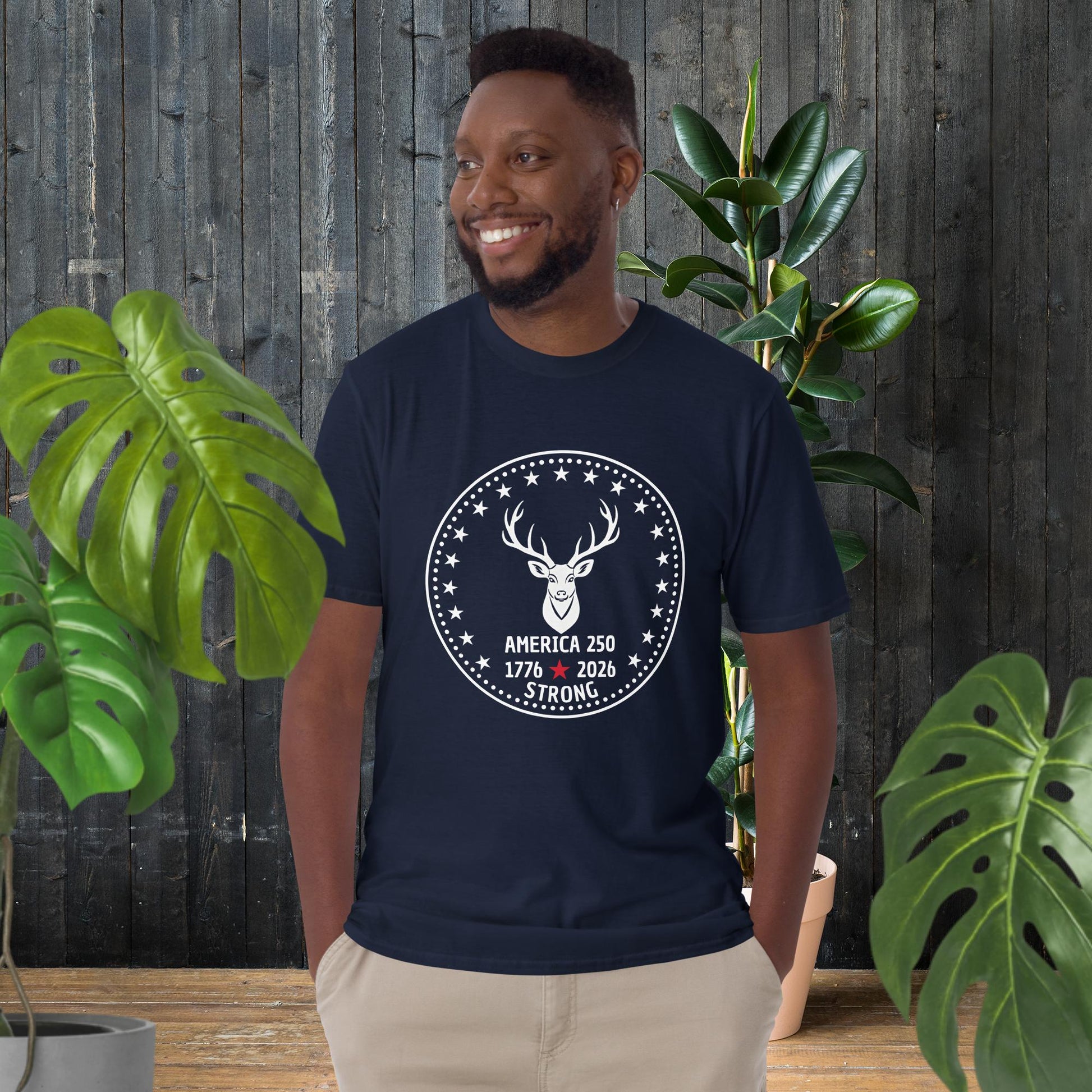 Man wearing navy t-shirt with deer graphic, 'America 250 Strong' text, stars, and 1776-2026 design