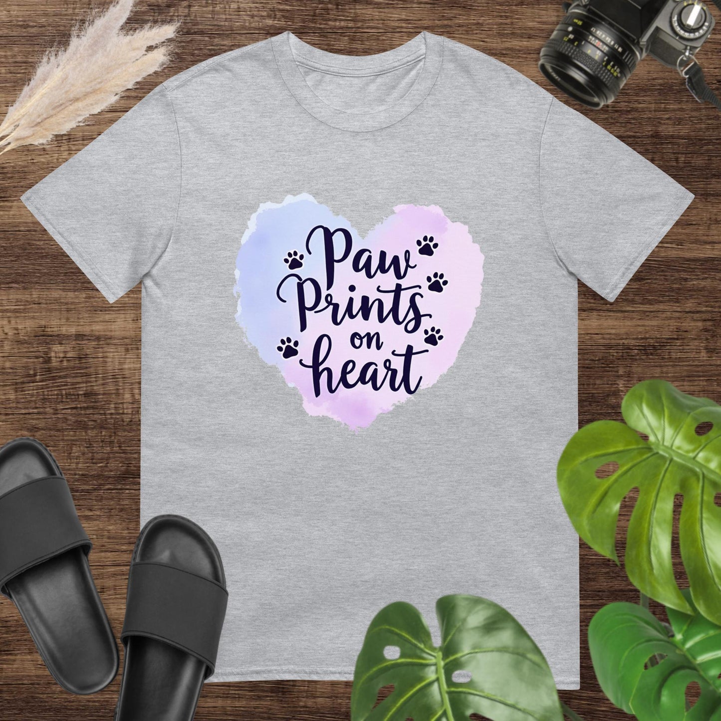 Grey t-shirt featuring a watercolor heart and paw prints around the text "Paw Prints on Heart"