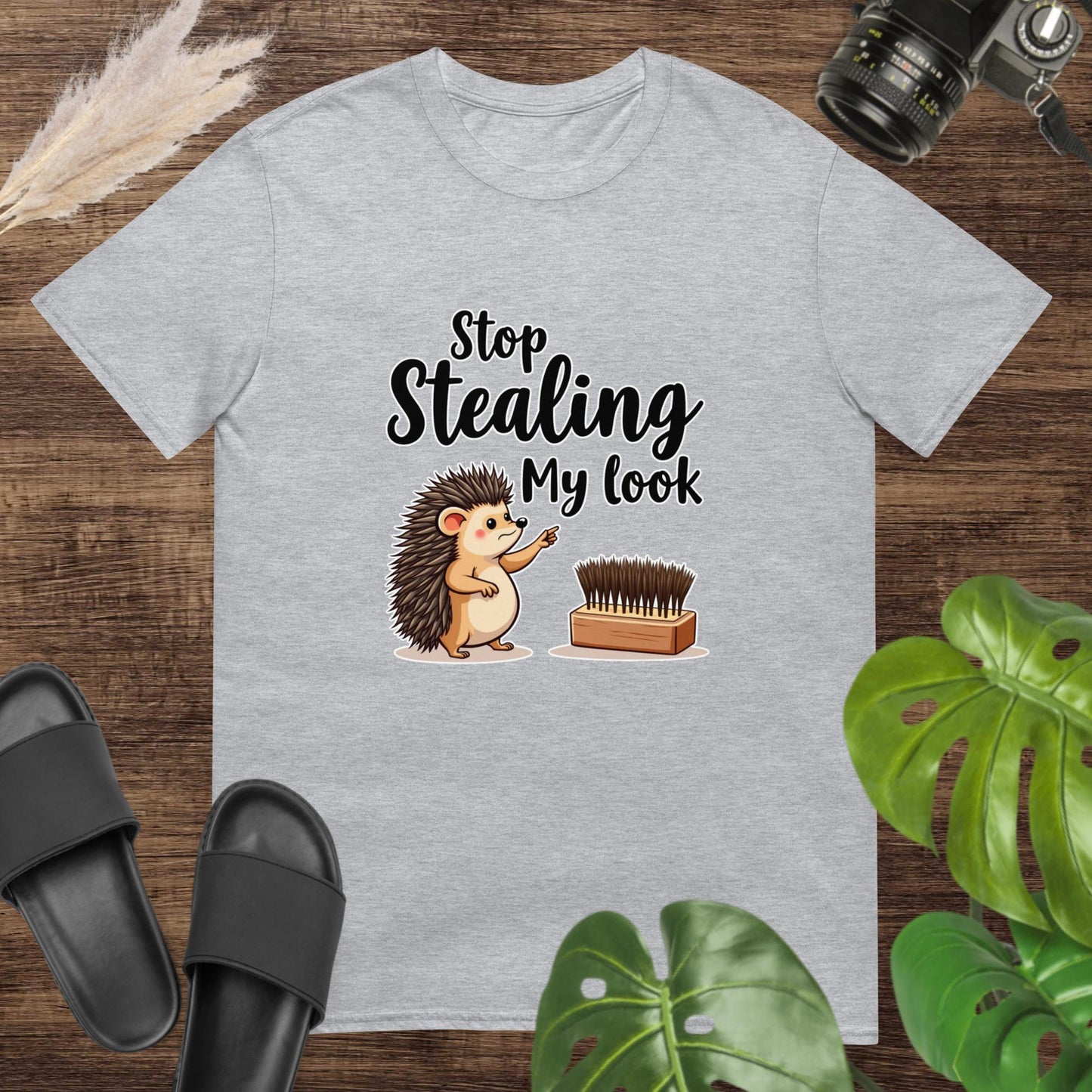Grey t-shirt featuring a hedgehog pointing at a hairbrush with the text "Stop stealing my look"