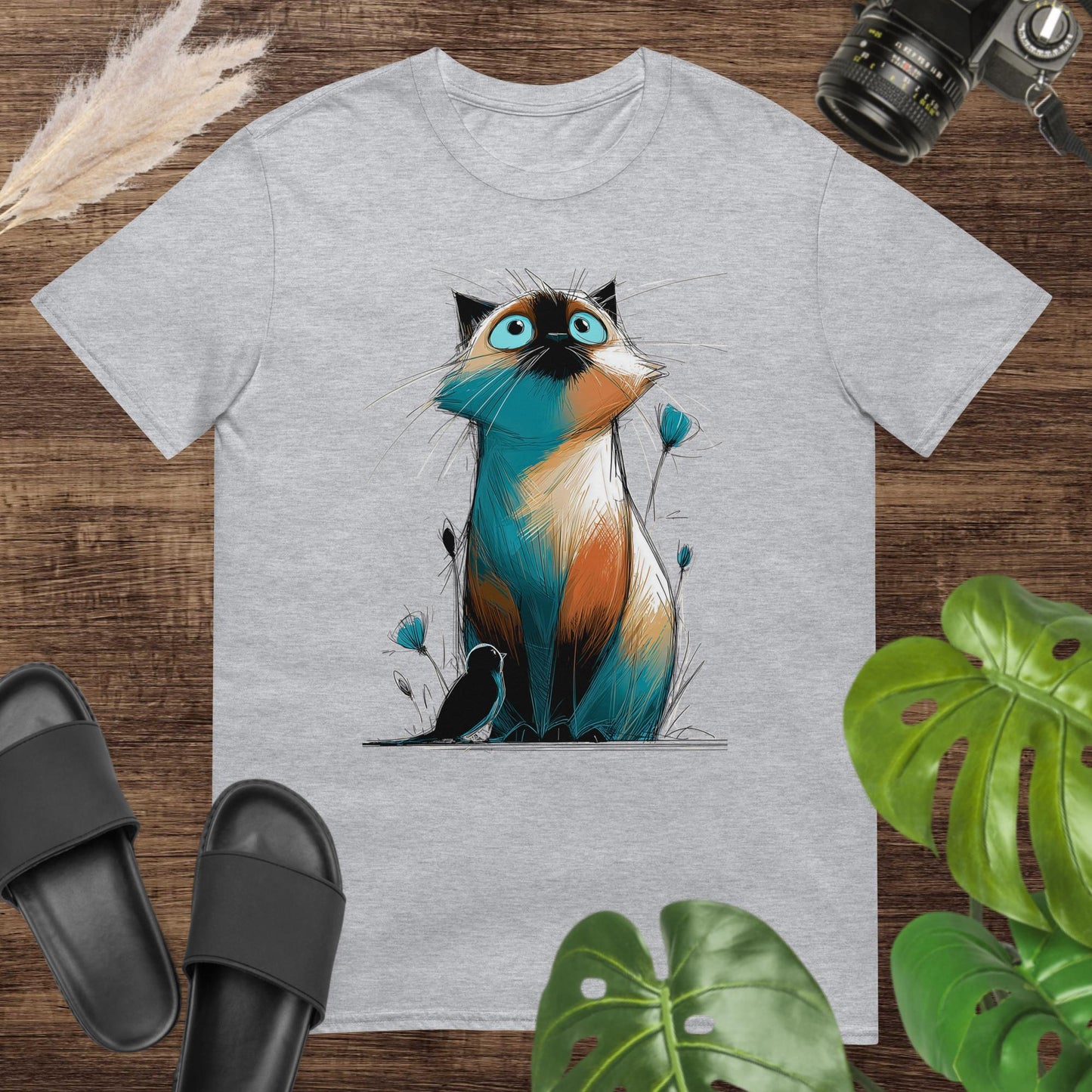 Unisex t-shirt featuring a colorful hand-drawn cat looking up at a small bird.