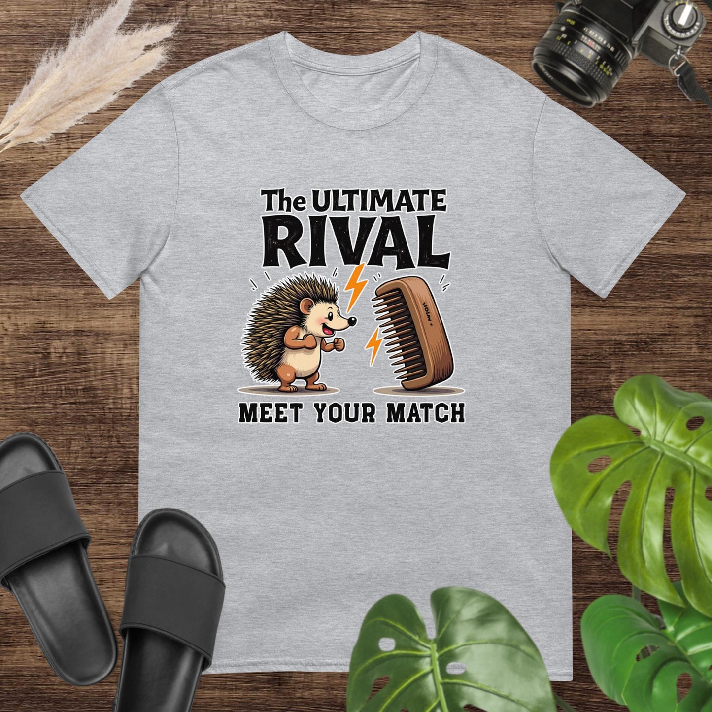 Quirky hedgehog grey t-shirt with a hairbrush rivalry and text "The ultimate rival. Meet yout match"