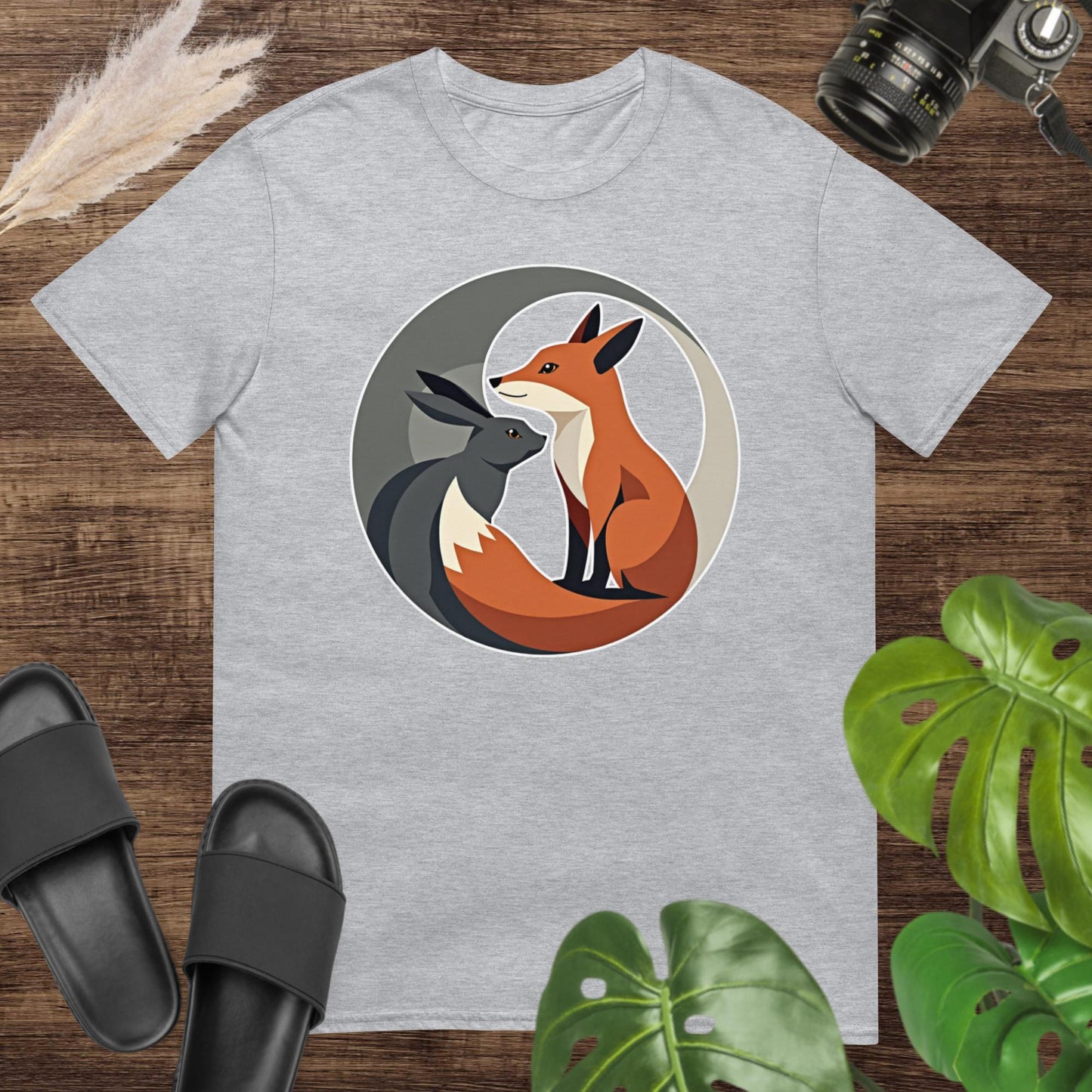 Elegant grey t-shirt featuring a fox and hare with a clean and balanced circular style.