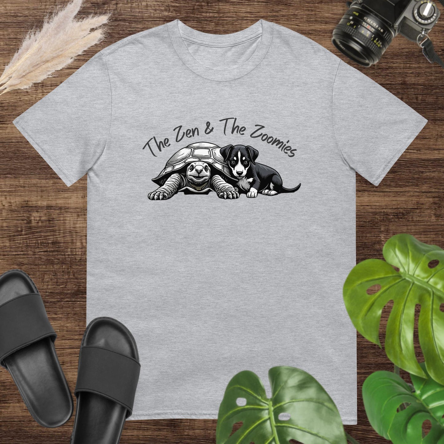 Grey t-shirt featuring a cute black & white turtle and puppy with the text "The Zne & The Zoomies"