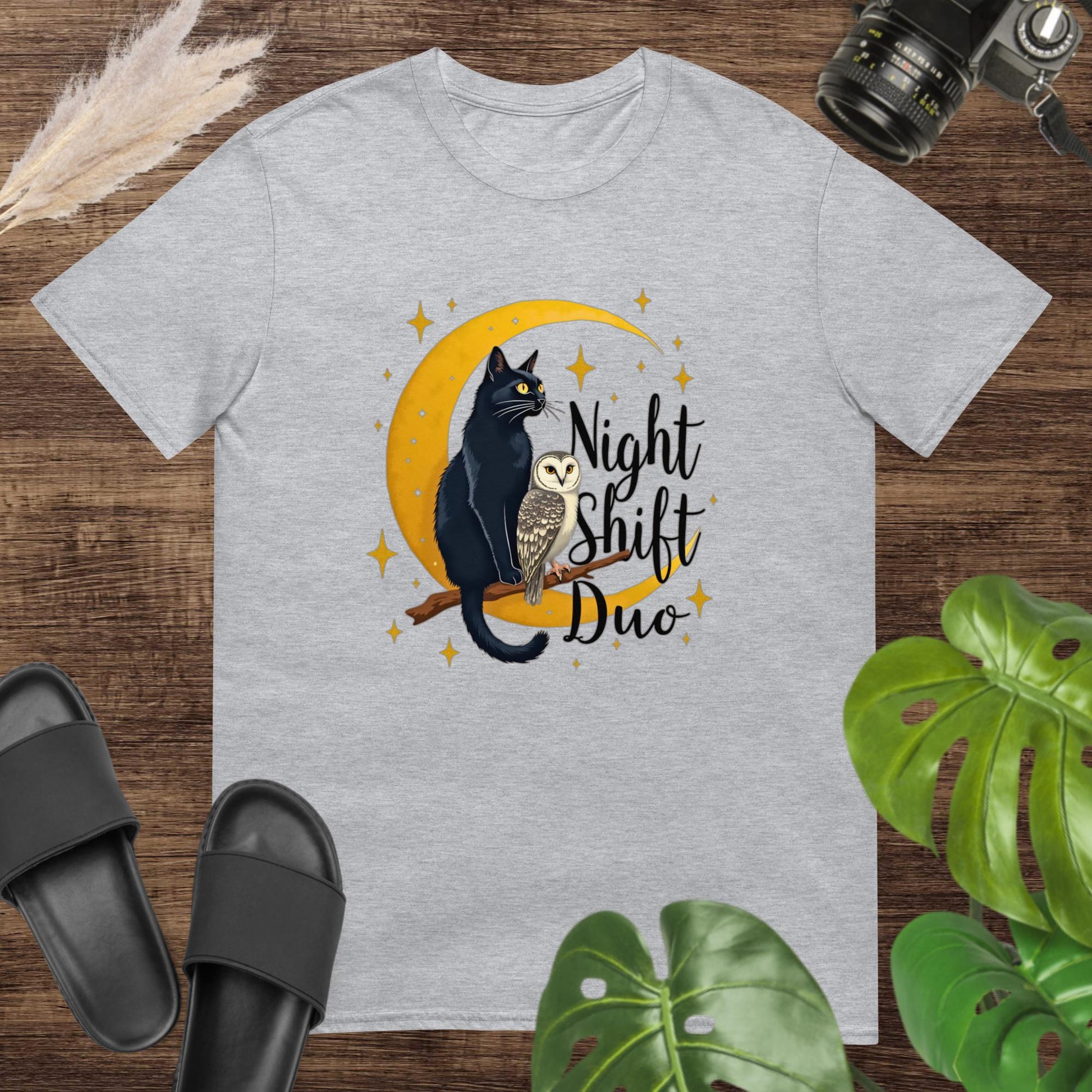 Cute grey t-shirt featuring a cat and owl on a moon and branch with the text "Night Shitf Duo"