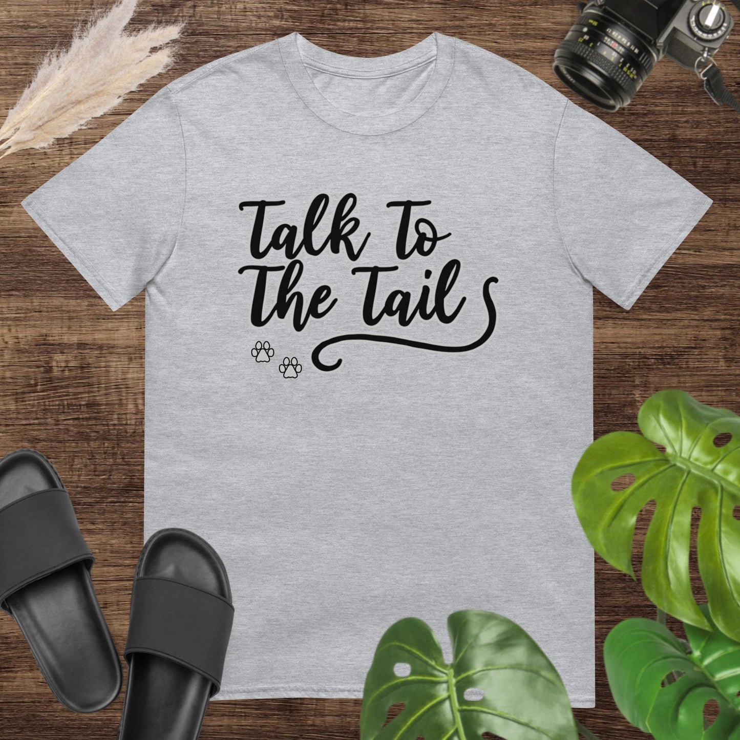 Funny grey t-shirt featuring a tail and 2 little paws after the text Talk to the Tail