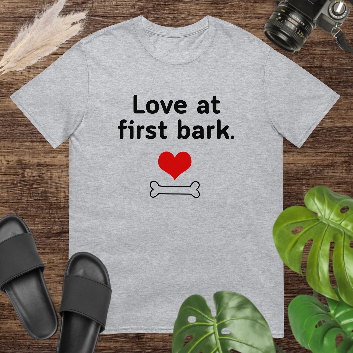 Cute grey t-shirt featuring a heart and a bone with text Love at first bark