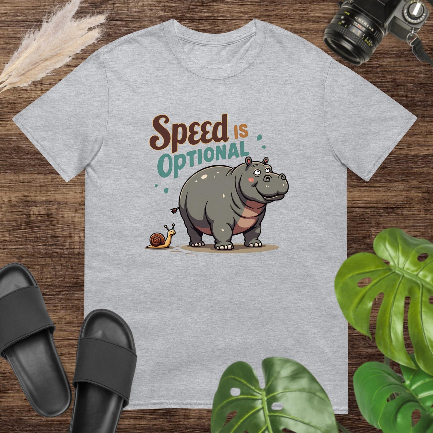 Unisex grey t-shirt featuring a hippo and snail with the text Speed Is Optional.