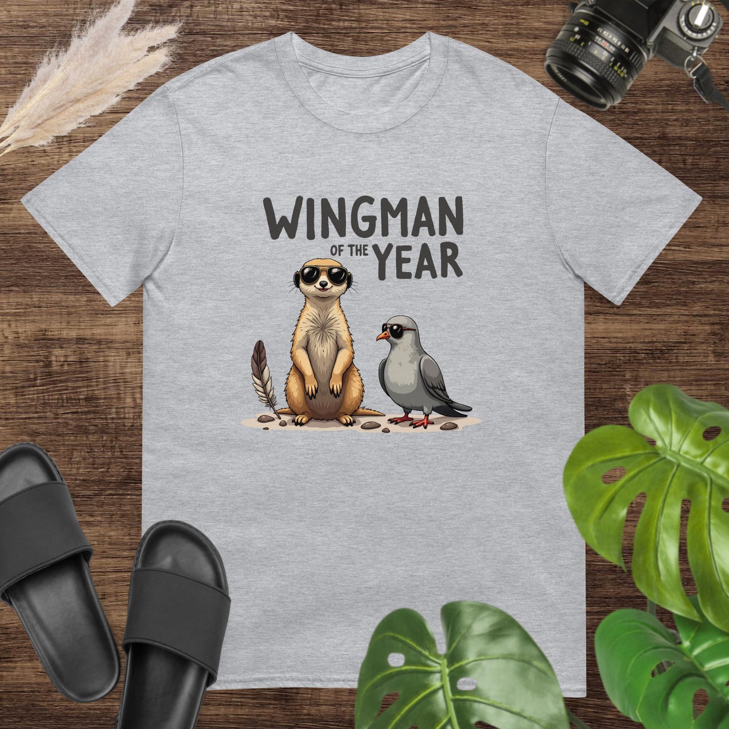Unisex grey t-shirt featuring a meerkat and a pigeon with the text Wingman of the Year.