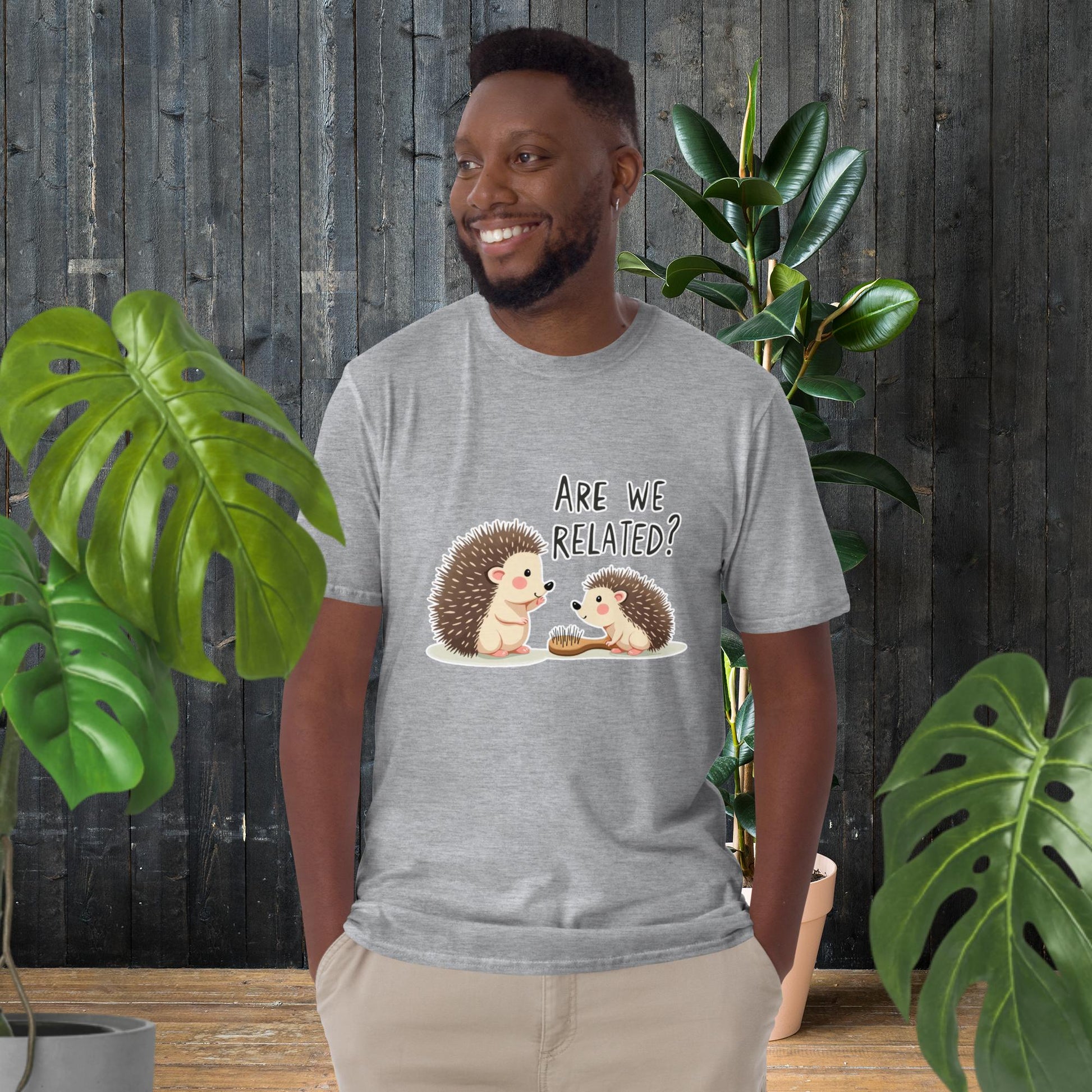 Man wearing funny hedgehog graphic tee with 'Are We Related?' text, cute animal duo design, unisex cotton t-shirt