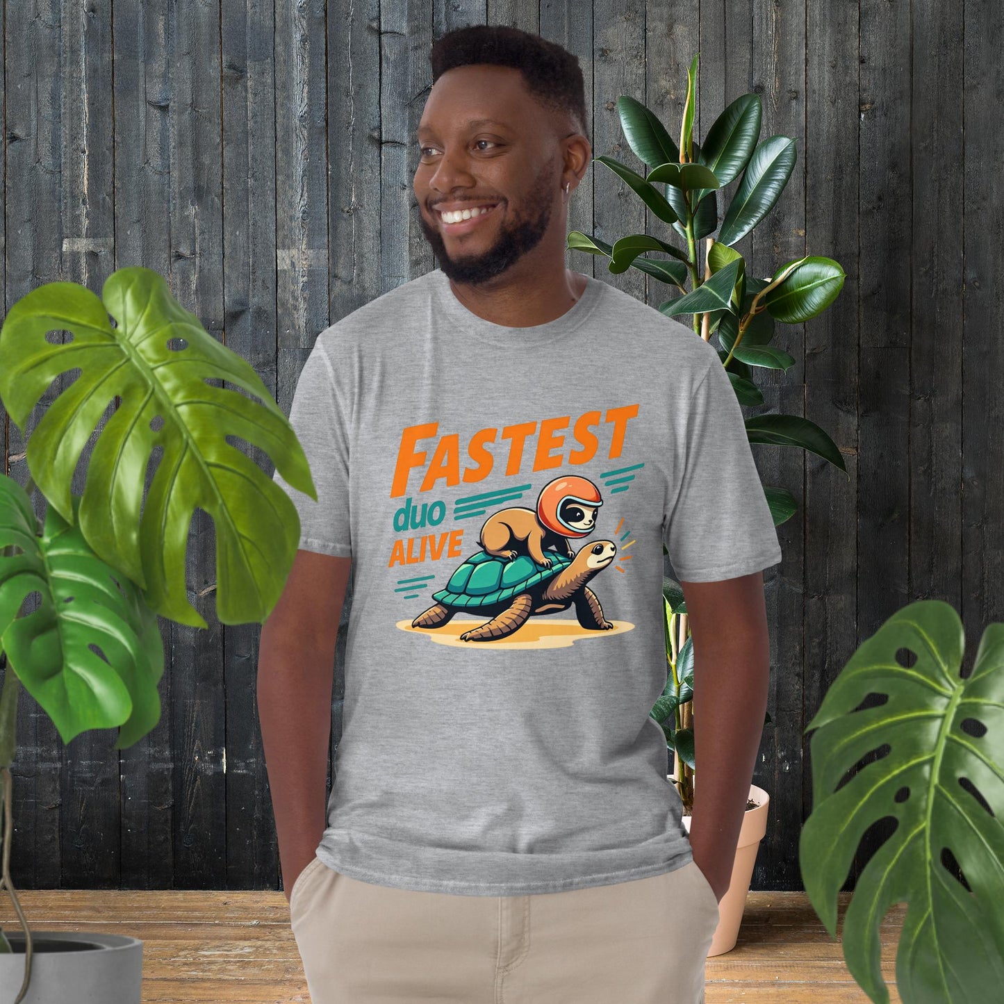 Man wearing funny unisex tee with sloth on turtle graphic, 'Fastest Duo Alive' text, perfect for pet lovers