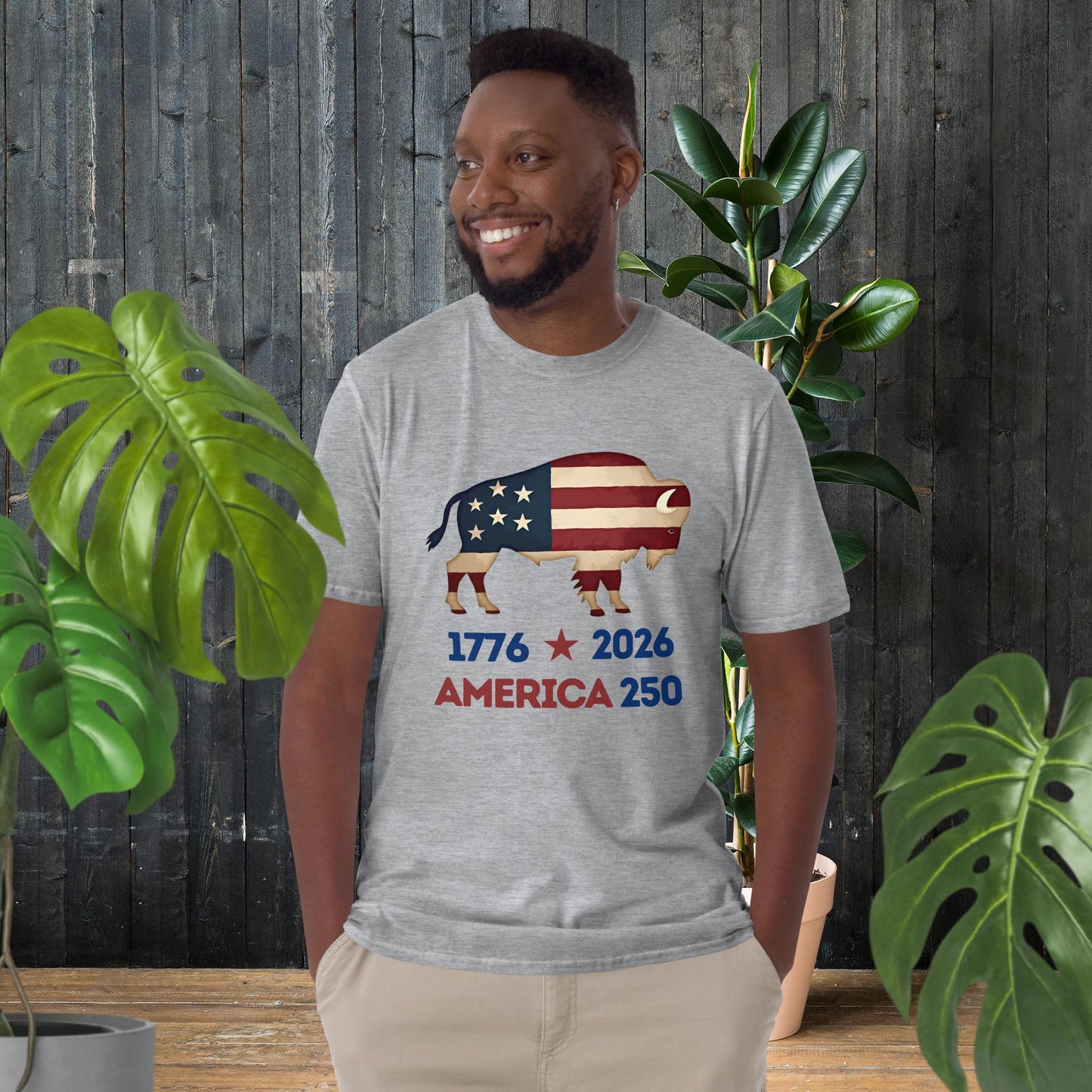 Man wearing gray unisex tee with American flag bison graphic, '1776 2026 America 250' text, perfect patriotic gift