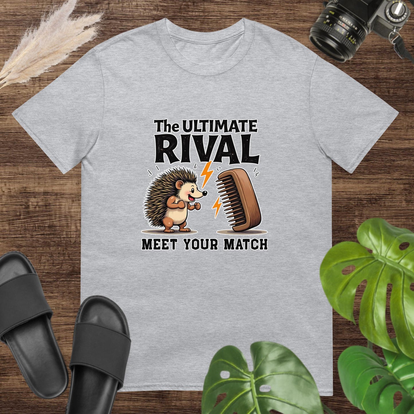 Quirky hedgehog gray t-shirt with a hairbrush rivalry and text "The ultimate rival. Meet yout match"