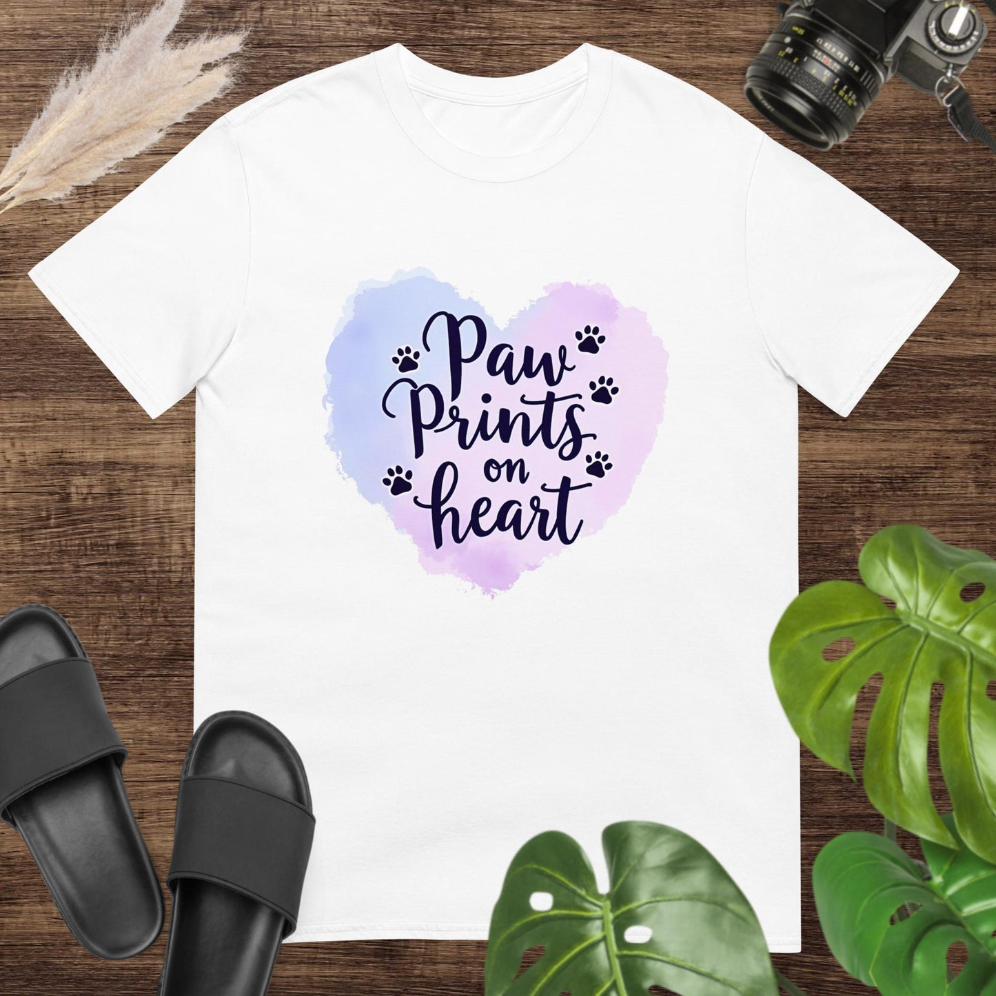 White t-shirt featuring a watercolor heart and paw prints around the text "Paw Prints on Heart"