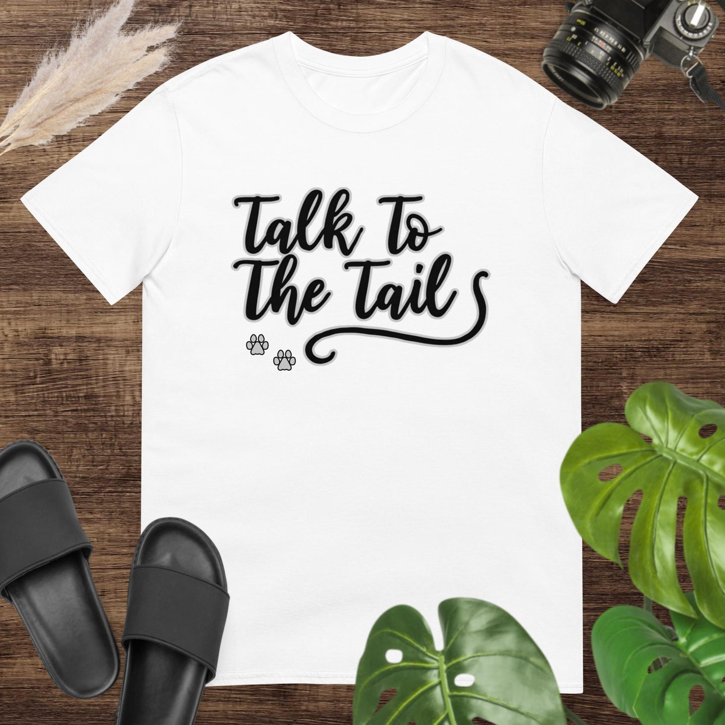 Funny white t-shirt featuring a tail and 2 little paws after the text Talk to the Tail