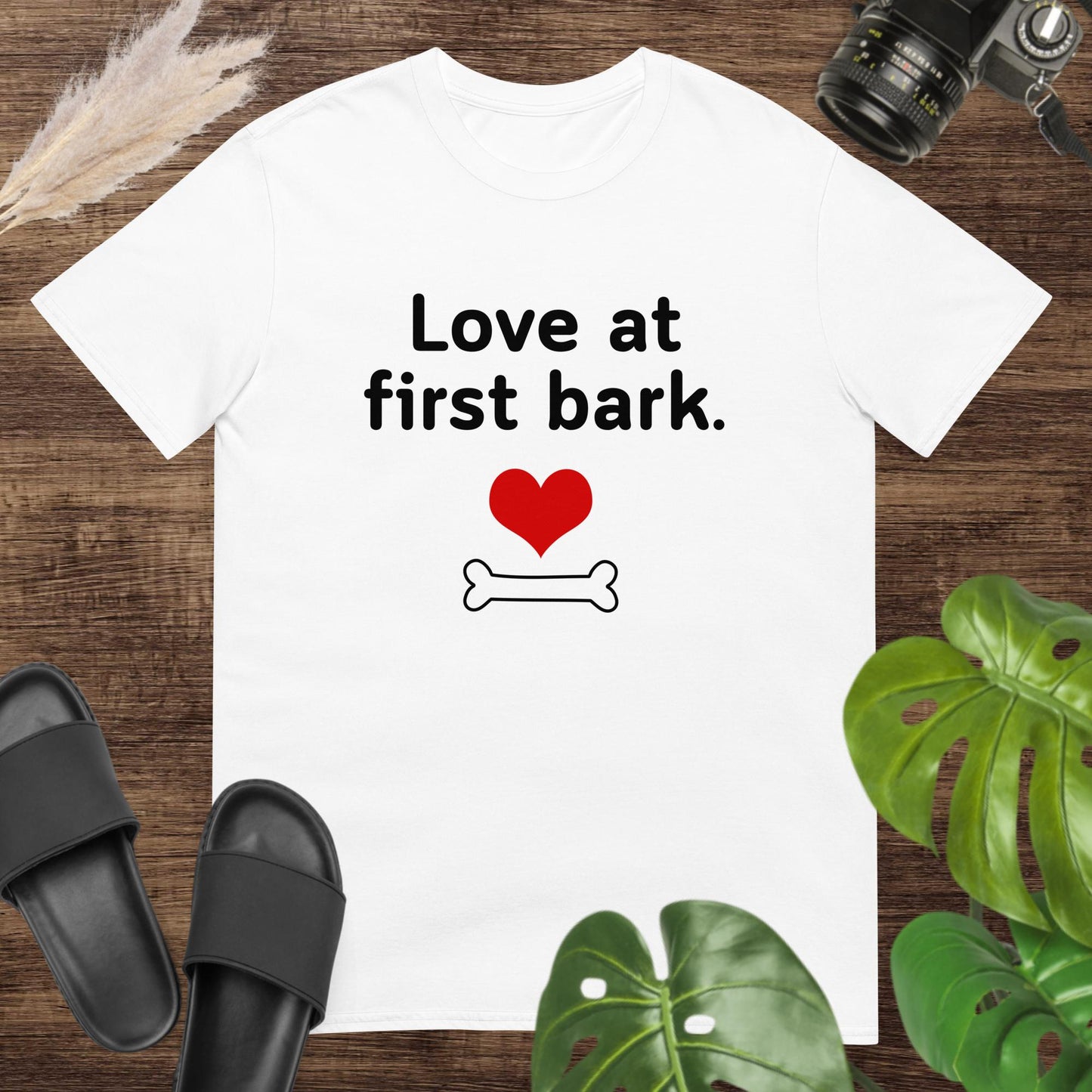 Cute white t-shirt featuring a heart and a bone with text Love at first bark