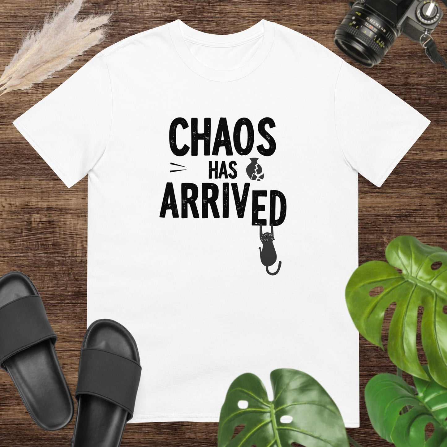 Funny white t-shirt featuring a cat breaking the word arrived in the text chaos has arrived