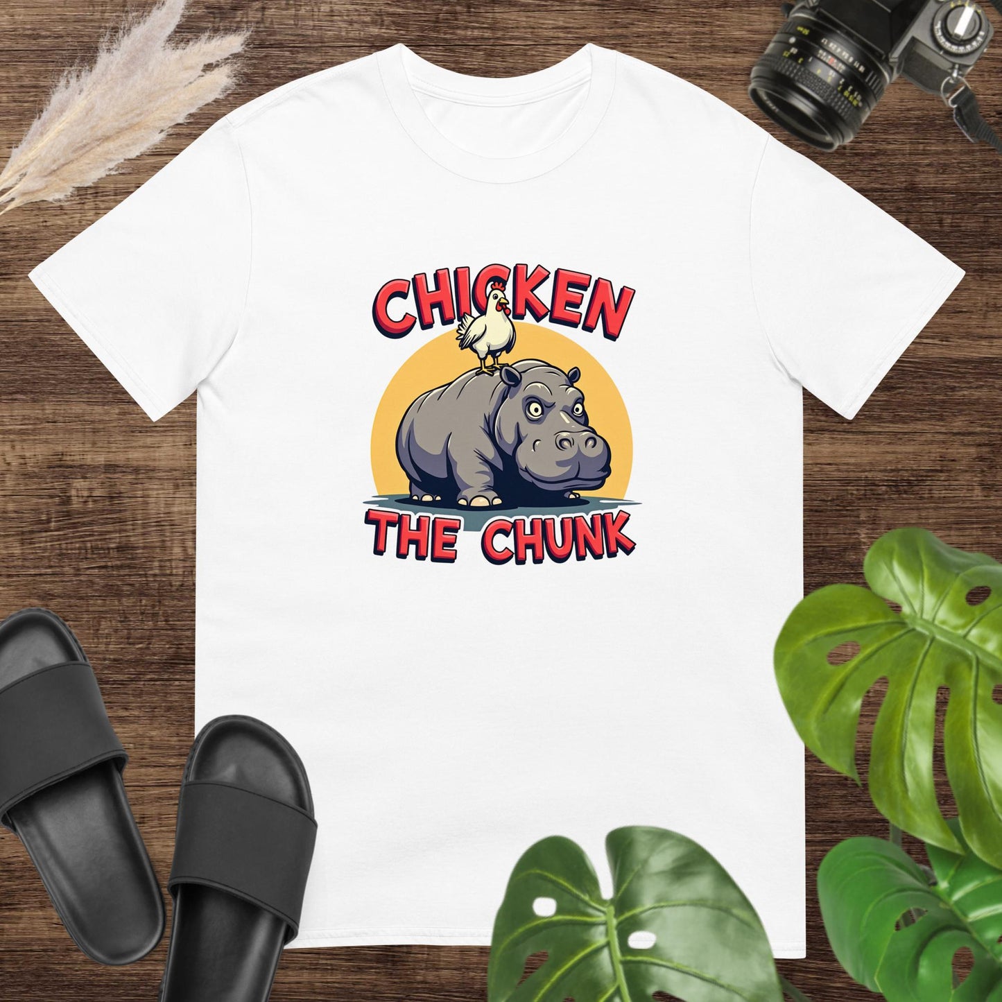 Unisex white t-shirt featuring a chicken standing on a hippo with the text Chicken the Chunk.