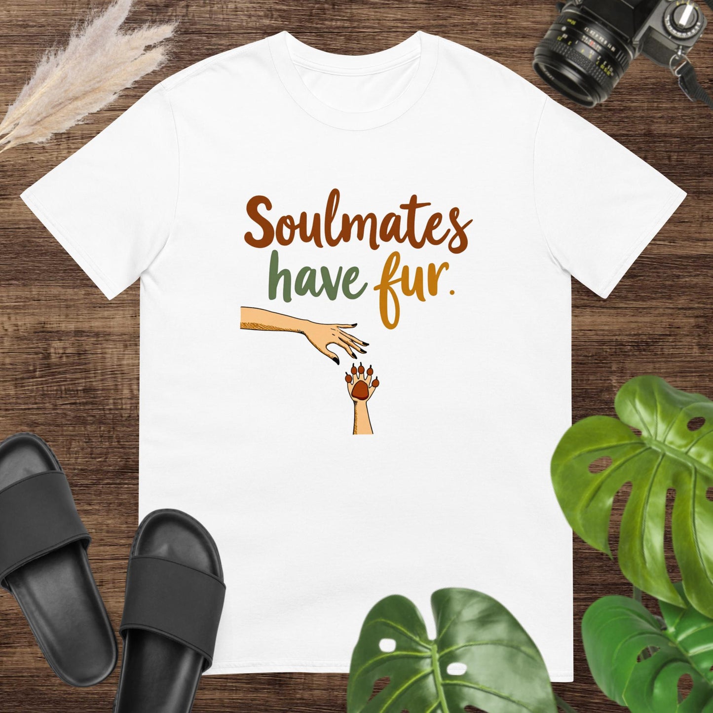 White t-shirt with text "Soulmates have fur" with a hand reaching a paw