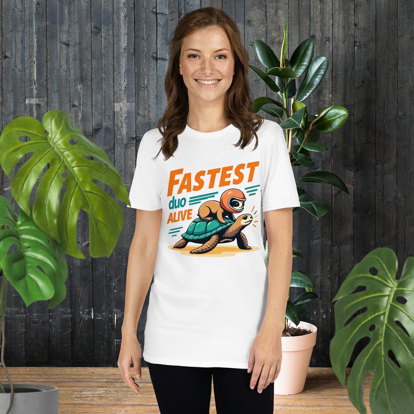 Funny unisex tee with sloth riding turtle, 'Fastest Duo Alive' graphic, perfect for pet lovers