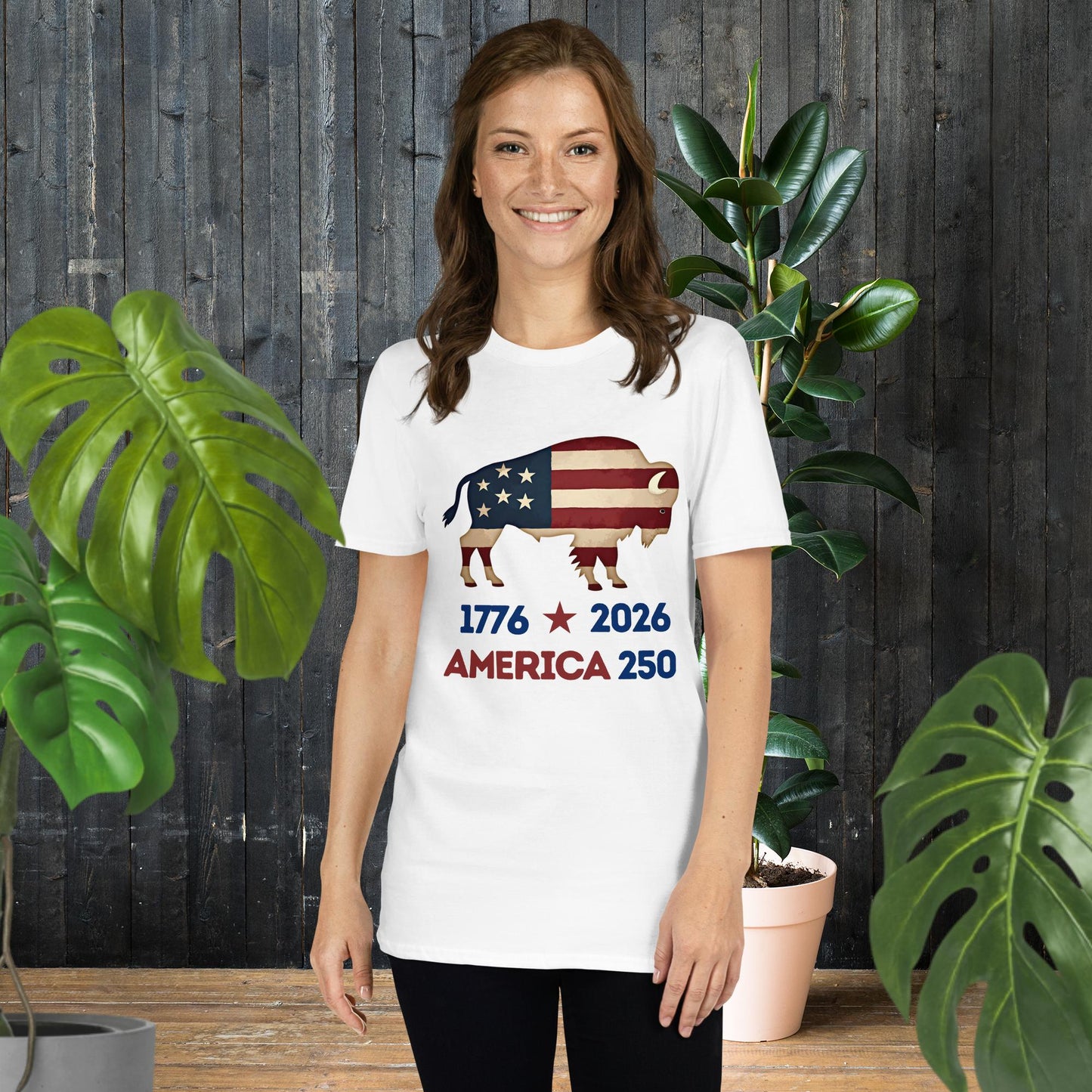 Woman wearing white tee with American flag bison graphic, '1776 2026 America 250' text, unisex patriotic shirt